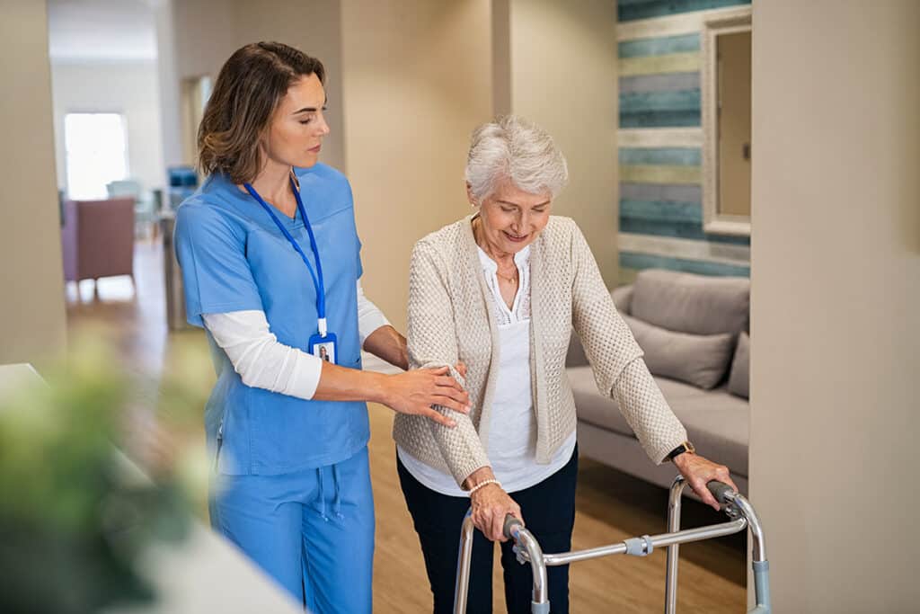 Nurse helping senior woman